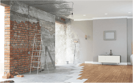 Interior of a room undergoing renovation with exposed brick wall, ladder, and partially installed wooden flooring.