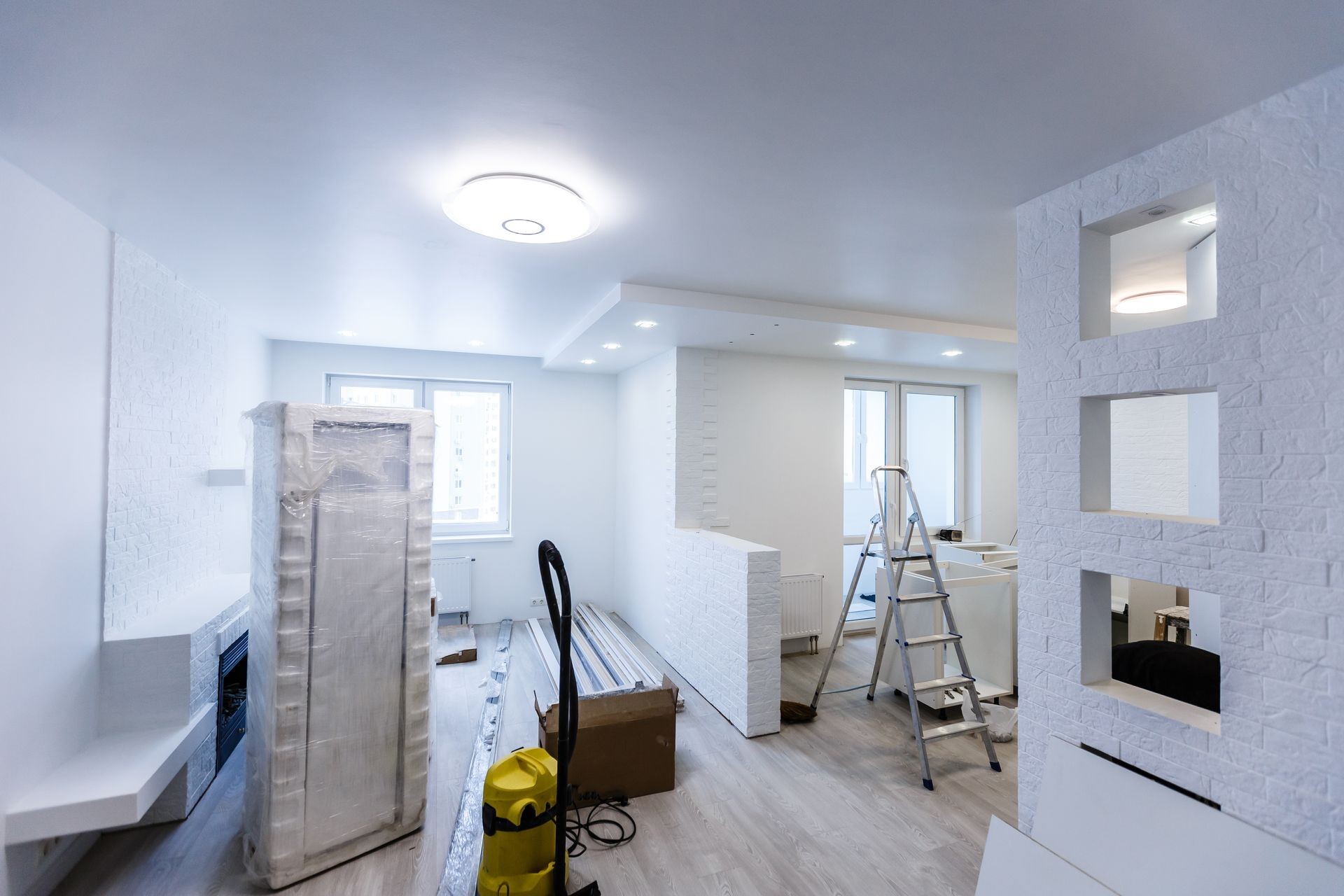 Custom kitchen cabinets in various stages of installation base for island in center